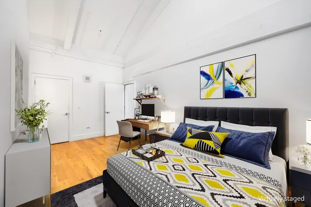 a living room with furniture and painting on the wall