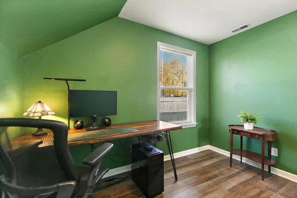 a view of a workspace with furniture and a window