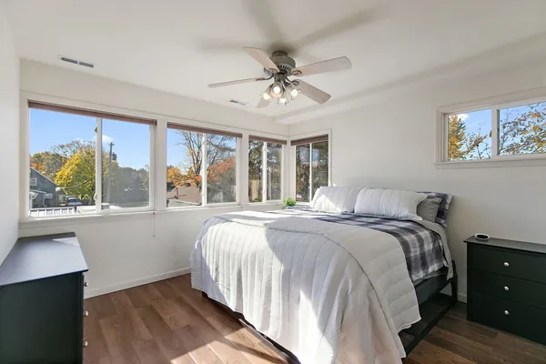 a bedroom with a large bed and a window