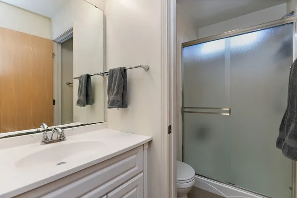 a bathroom with a sink toilet and shower