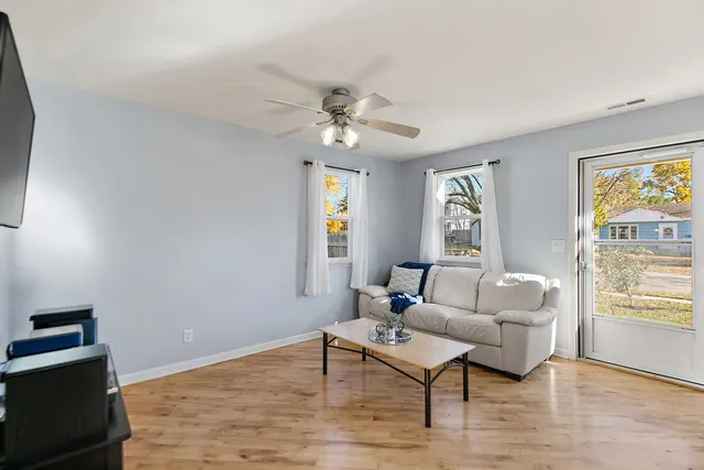 a living room with furniture a window and a flat screen tv