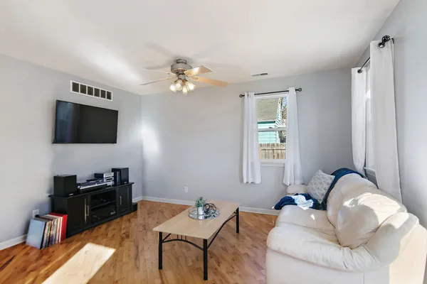 a living room with furniture and a flat screen tv