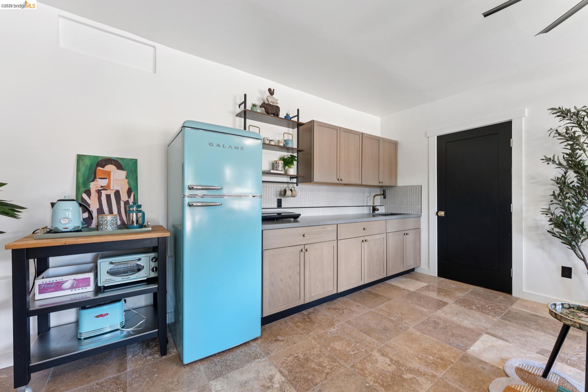 2301 Oak Street Berkeley, CA 94708 - Photo 52 of 61 Kitchenette featuring light wood-finish cabinetry, a black sink, and white subway tile backsplash