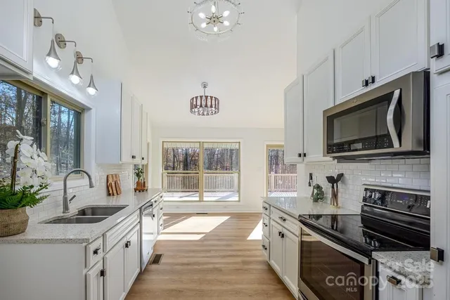 a bathroom with a granite countertop sink a mirror and shower