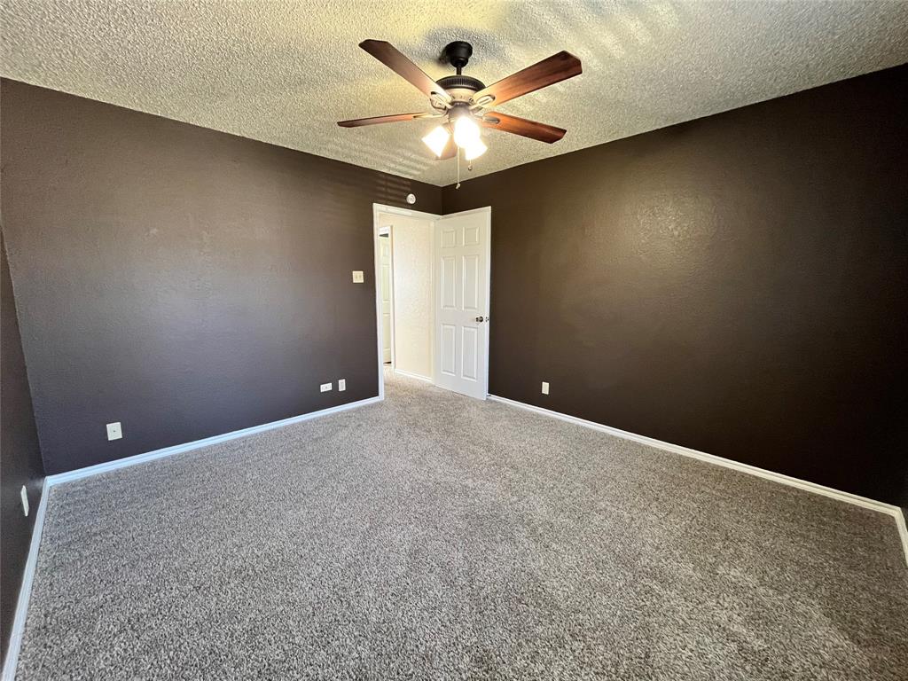 524 Strata Drive Denton, TX 76201 - Photo 11 of 17 Notice the plush carpet and the lighting from the ceiling fan.