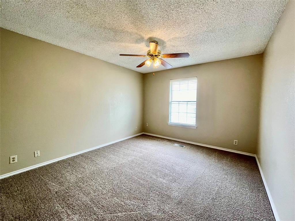524 Strata Drive Denton, TX 76201 - Photo 12 of 17 an empty room with a window and a ceiling fan