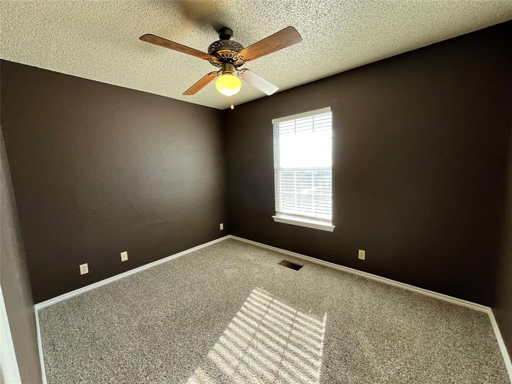 524 Strata Drive Denton, TX 76201 - Photo 12 of 17 This space has plush carpet, natural lighting from the window, and a lighted ceiling fan.