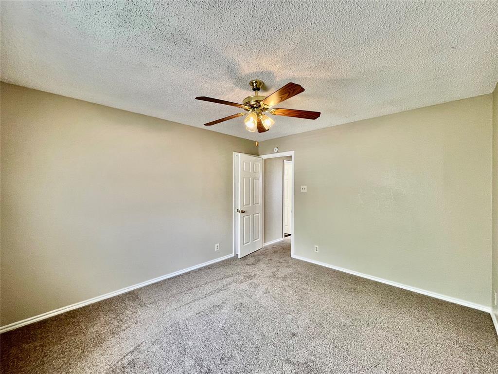 524 Strata Drive Denton, TX 76201 - Photo 13 of 17 an empty room with a window and a fan