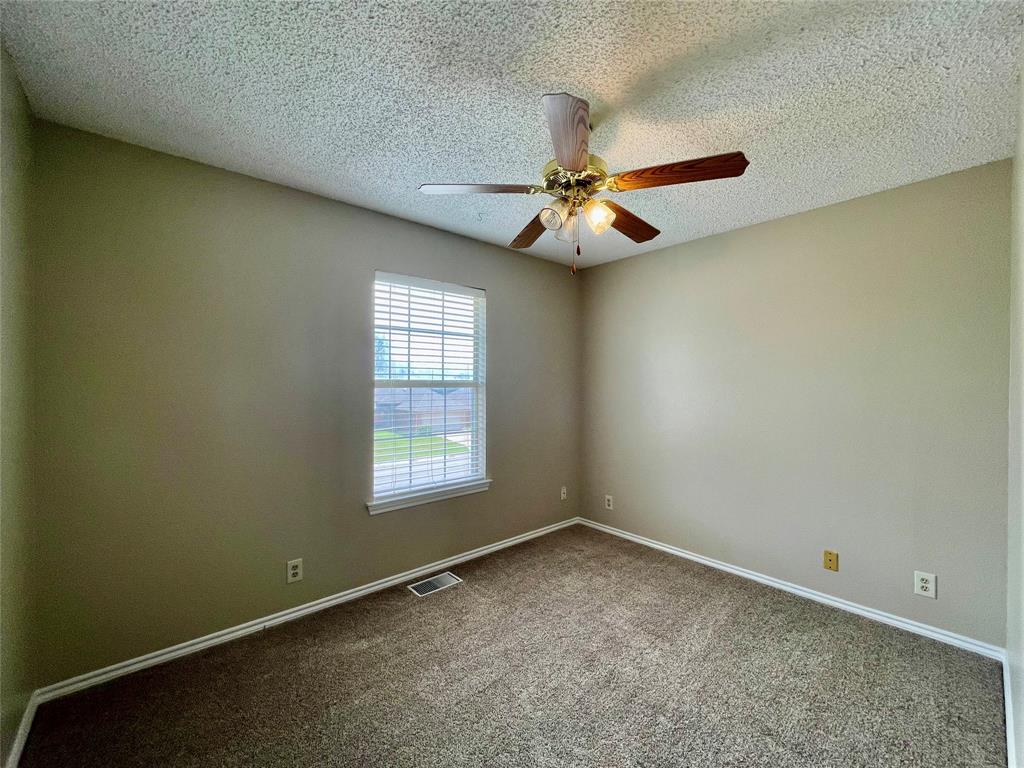 524 Strata Drive Denton, TX 76201 - Photo 14 of 17 an empty room with a window and a fan