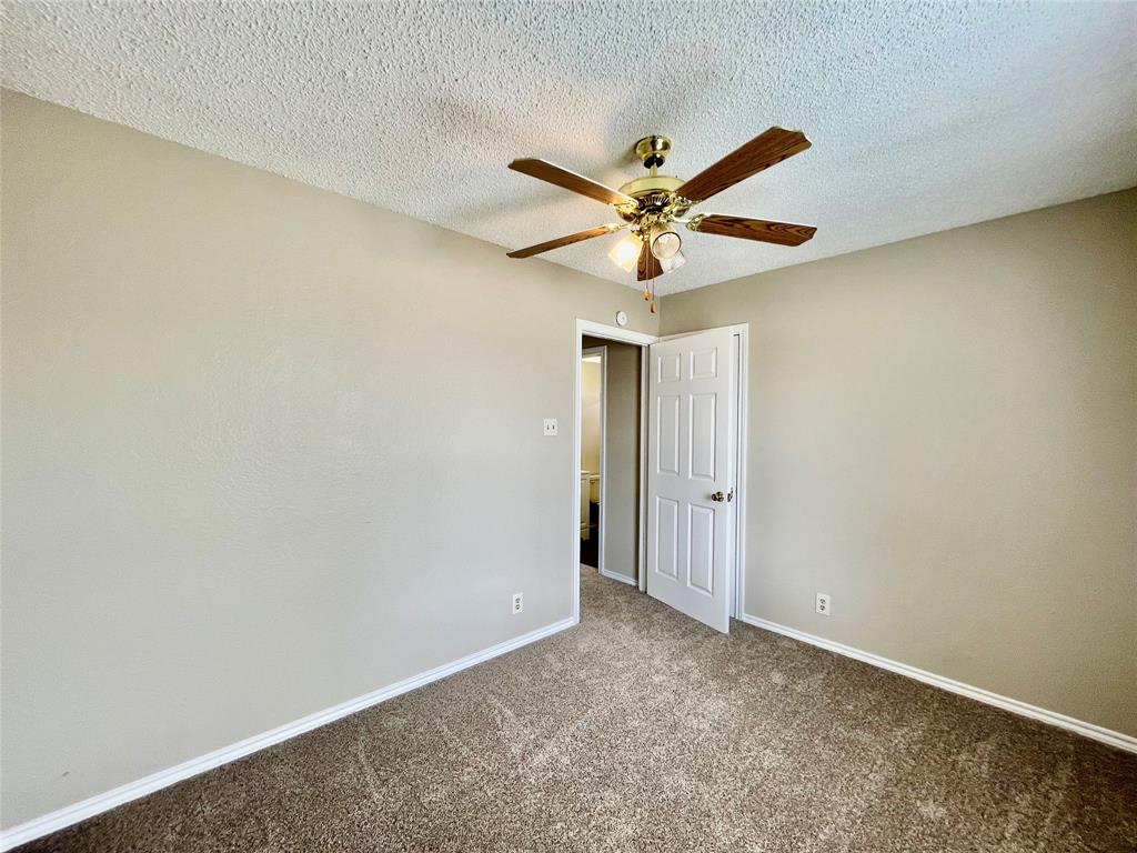 524 Strata Drive Denton, TX 76201 - Photo 15 of 17 an empty room with a ceiling fan and a window