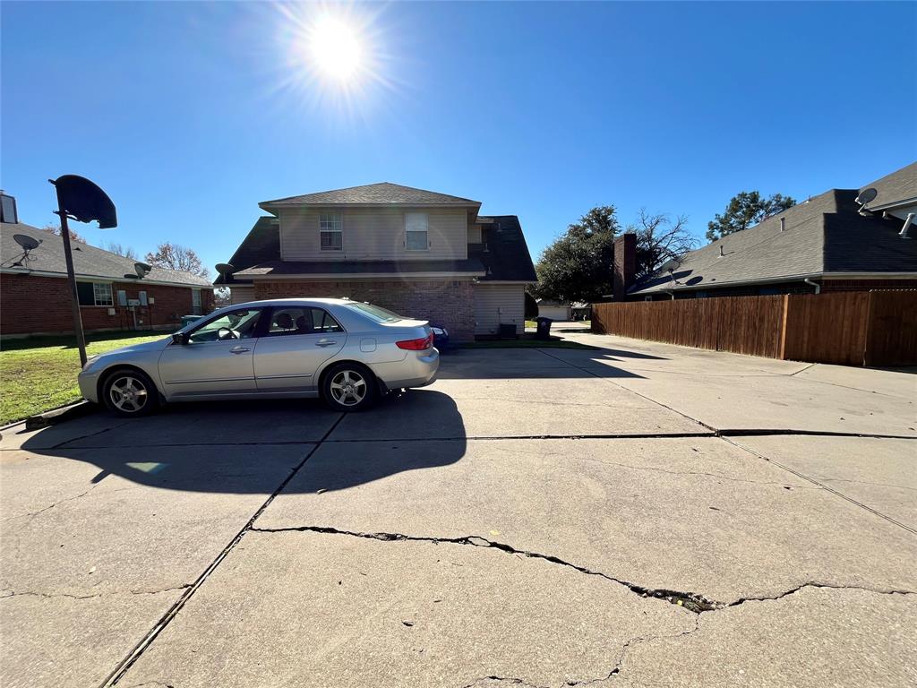 524 Strata Drive Denton, TX 76201 - Photo 17 of 17 Notice that parking is in the back of the property. This view shows a generous amount of concrete with a great basketball hoop.