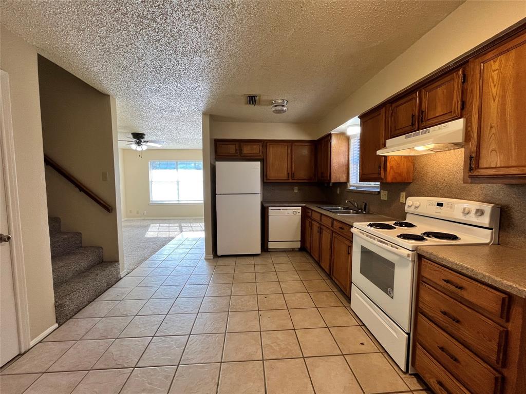 524 Strata Drive Denton, TX 76201 - Photo 4 of 17 This open space shows access to the staircase and the living room.