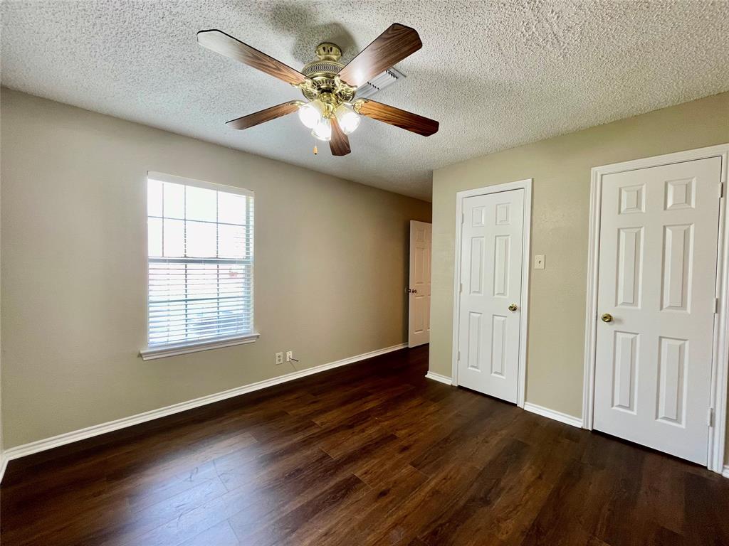 524 Strata Drive Denton, TX 76201 - Photo 8 of 17 a view of an empty room with wooden floor and a window