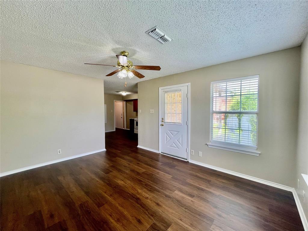 524 Strata Drive Denton, TX 76201 - Photo 10 of 17 a view of an empty room with wooden floor and a window