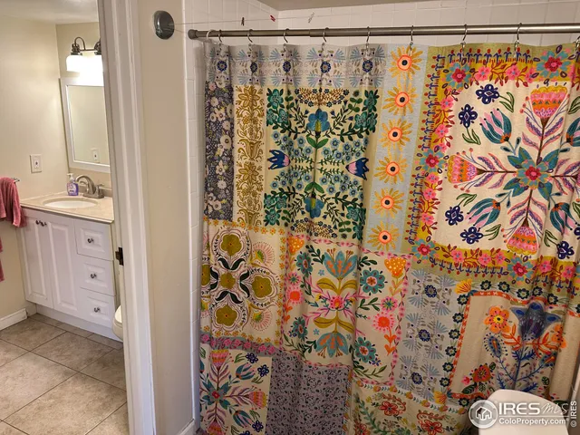 a bathroom with a shower curtain and a shower curtain