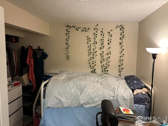 a bedroom with a bed and a painting on the wall