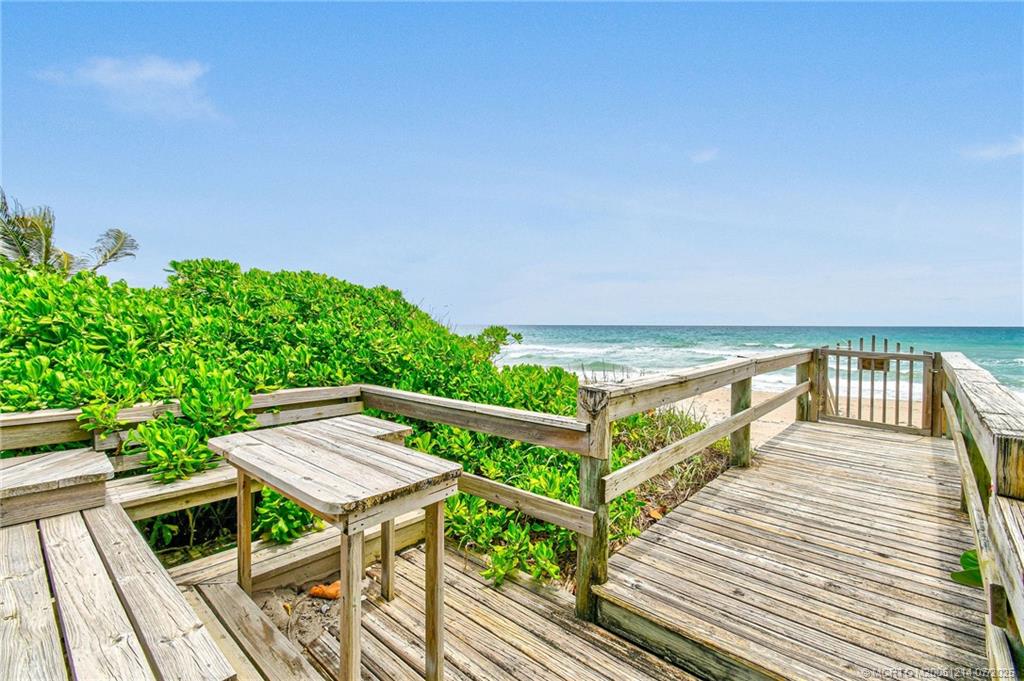 108 Island Dunes Cove Jensen Beach, FL 34957 - Photo 21 of 35 a view of a balcony with wooden floor and outdoor seating