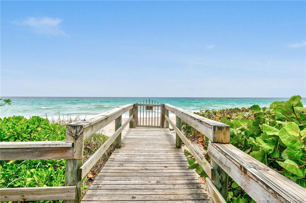 108 Island Dunes Cove Jensen Beach, FL 34957 - Photo 22 of 35 a view of a balcony with wooden floor and lake view
