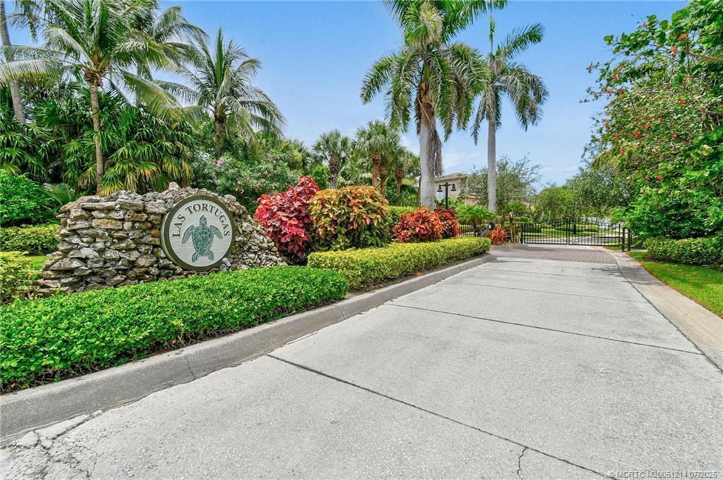 108 Island Dunes Cove Jensen Beach, FL 34957 - Photo 26 of 35 a front view of a house with a garden and a tree
