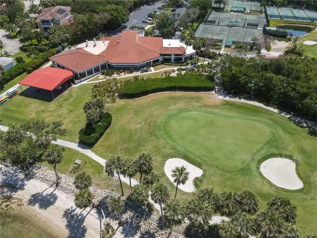 a aerial view of a house with a swimming pool and outdoor seating