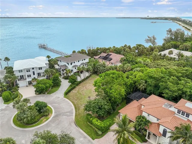 an aerial view of a house with a lake view