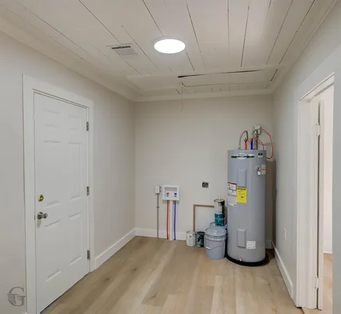 a view of storage and utility room with wooden floor