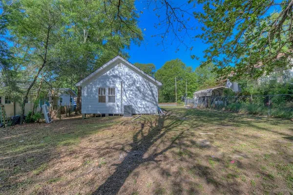 a view of a house with a backyard