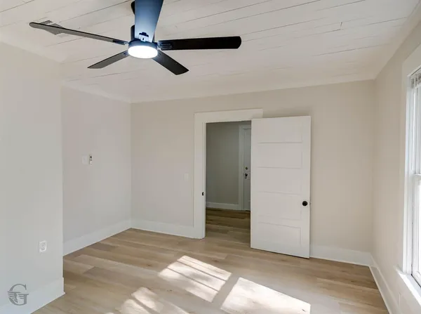 a view of a livingroom with a ceiling fan and window