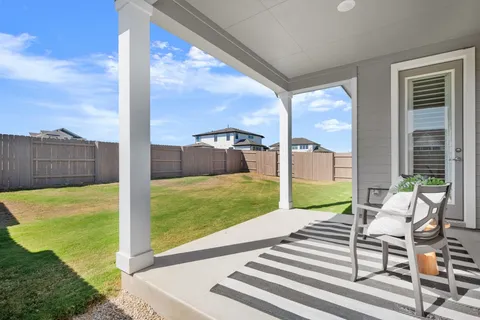 a view of a chairs in back yard of the house