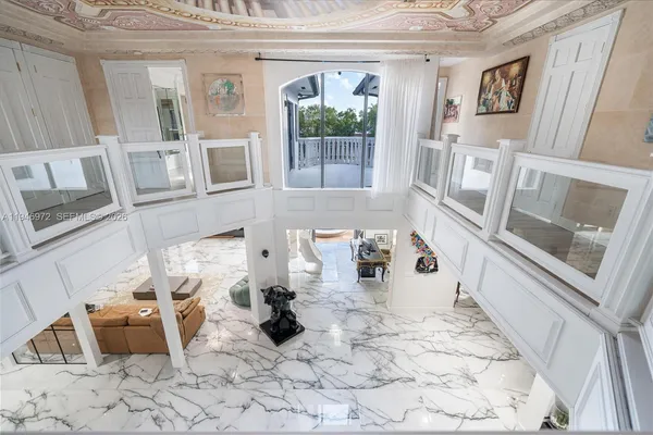 a dining room with furniture a rug and white walls