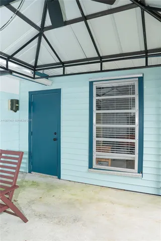 a view of a room with a bed and a window