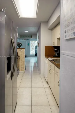 a kitchen with stainless steel appliances a refrigerator sink and cabinets