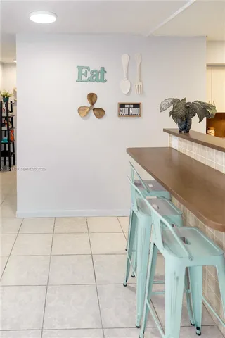 a kitchen with granite countertop a refrigerator and a stove top oven