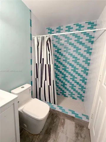 a bedroom with a bed and a lamp on table