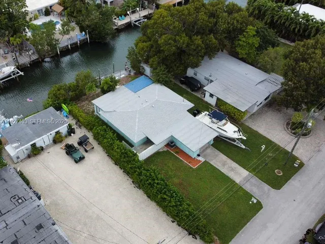 an aerial view of a house with garden space and lake view