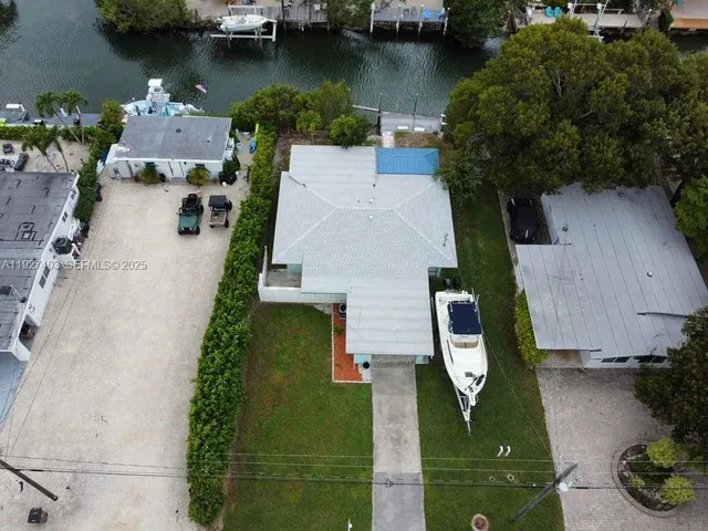 an aerial view of house with yard swimming pool and outdoor seating