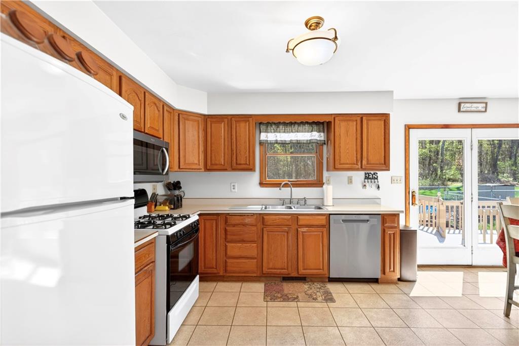 24 Sevich Alley Monongahela, PA 15063 - Photo 21 of 48 a kitchen with stainless steel appliances granite countertop a stove a sink and a refrigerator