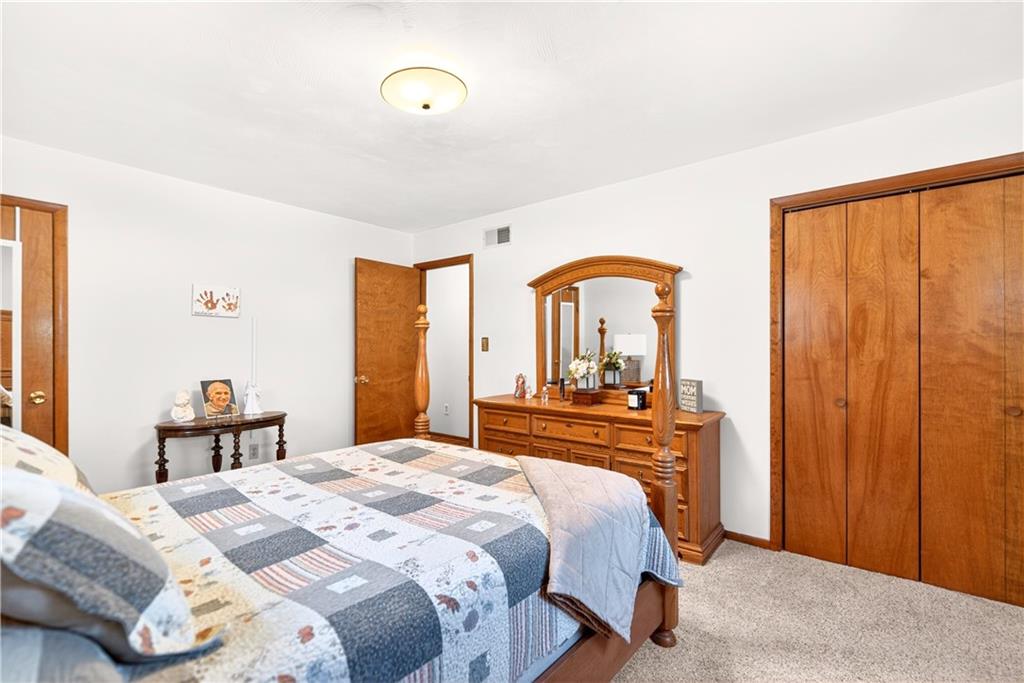 24 Sevich Alley Monongahela, PA 15063 - Photo 29 of 48 a bedroom with a large bed and wooden floor