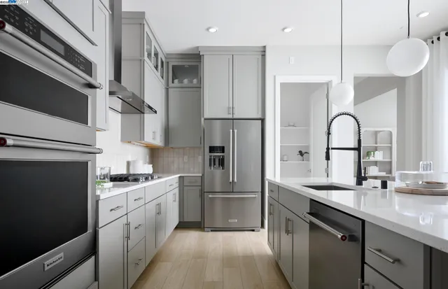 a kitchen with a sink stainless steel appliances and cabinets