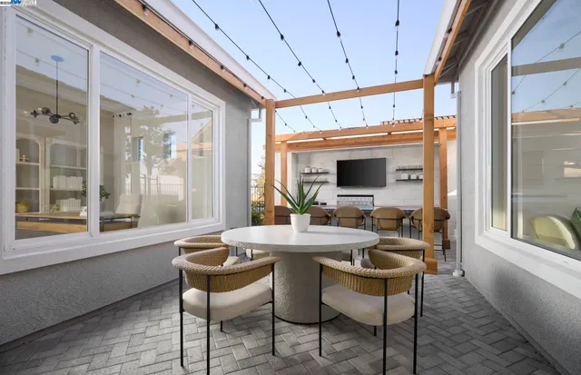 a outdoor dining space with furniture and window