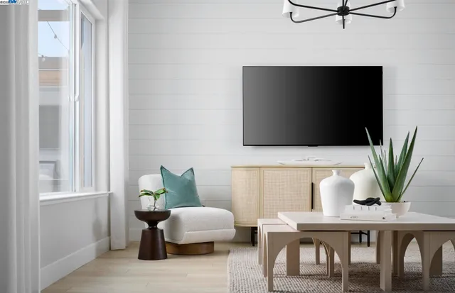 a living room with furniture wooden floor and a flat screen tv