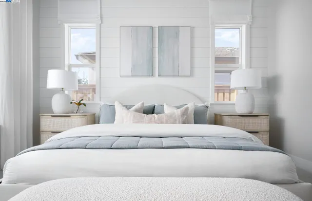 a bedroom with a bed and lamp with window