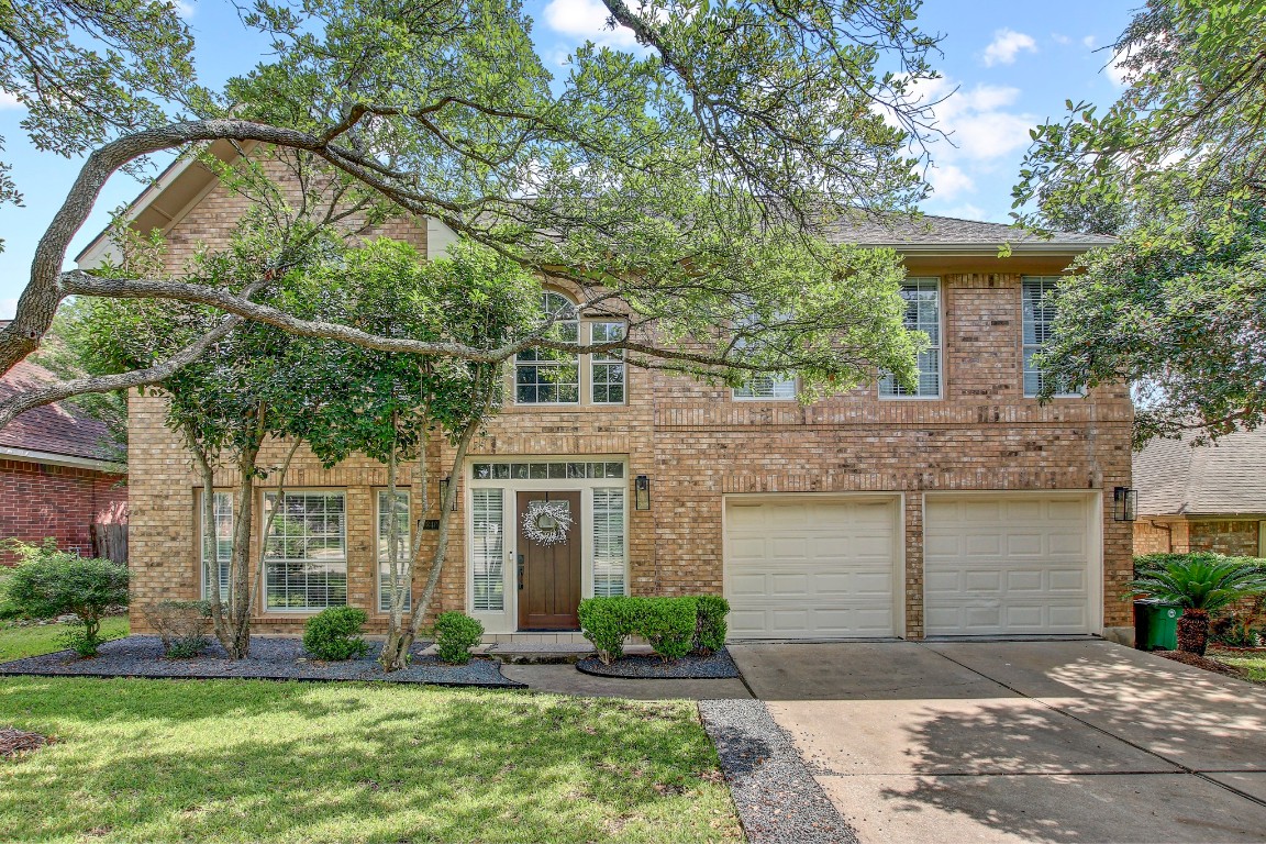 10840 Redmond Road Austin, TX 78739 - Photo 1 of 1 a front view of a house with a yard and garage
