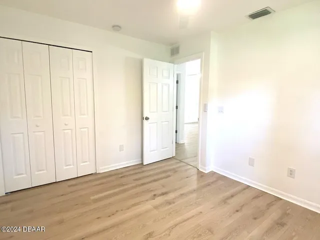 a view of a room with wooden floor