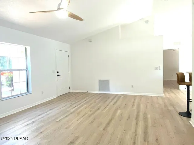 an empty room with windows and entrance