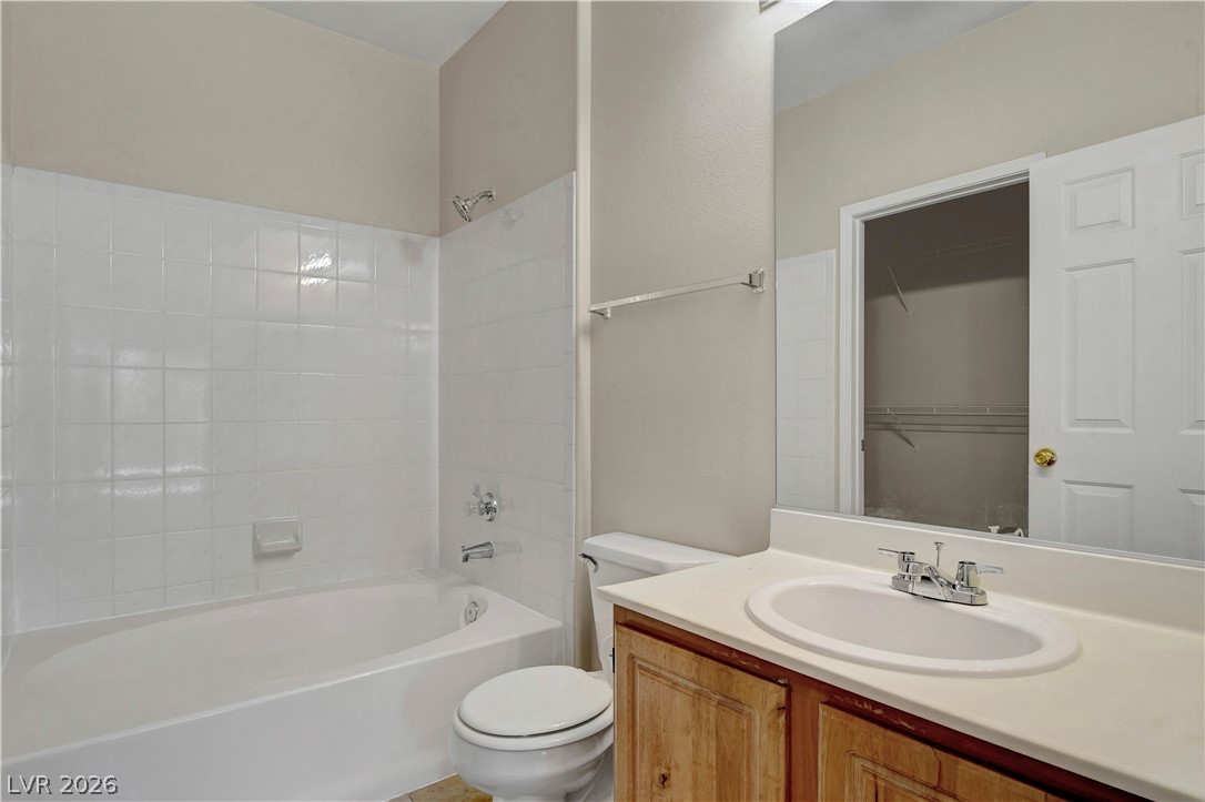 8555 West Russell Road, Unit 2091 Las Vegas, NV 89113 - Photo 13 of 26 Bathroom featuring vanity, bathtub / shower combination, and a spacious closet