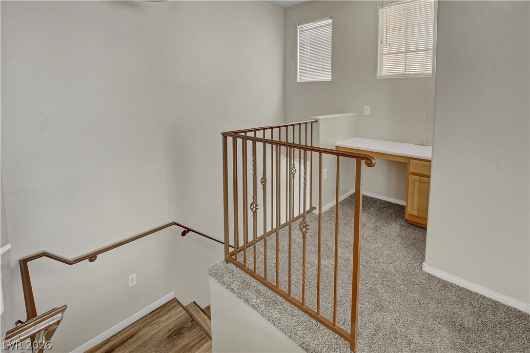 8555 West Russell Road, Unit 2091 Las Vegas, NV 89113 - Photo 21 of 26 Stairs with built in desk and carpet flooring