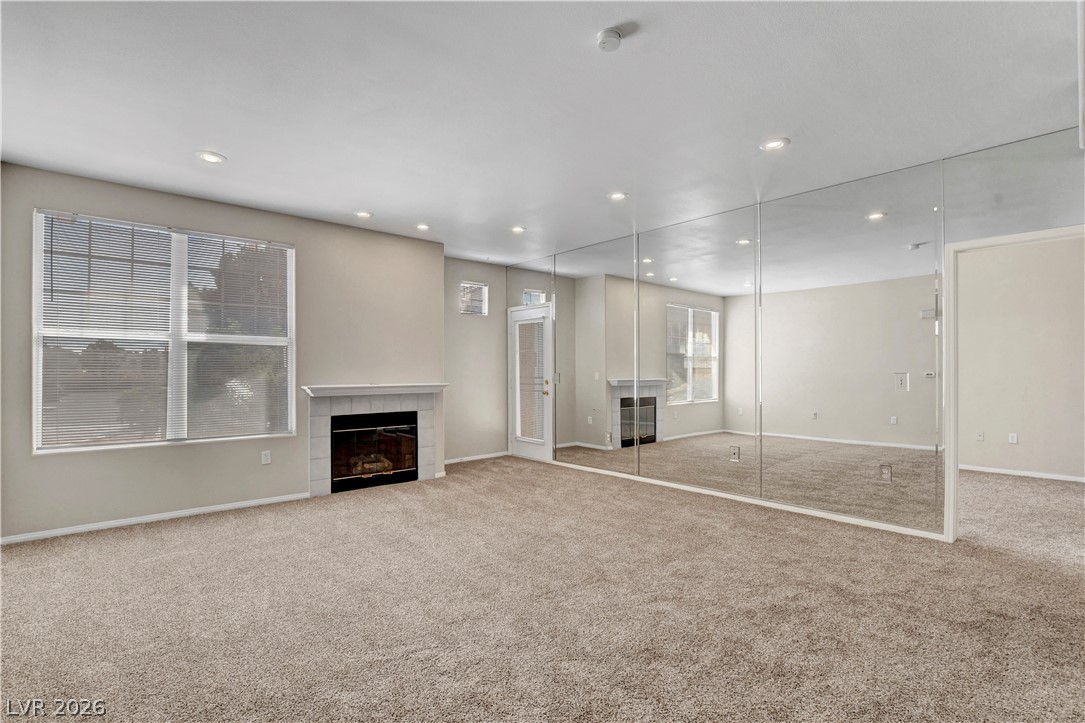 8555 West Russell Road, Unit 2091 Las Vegas, NV 89113 - Photo 3 of 26 Living room with a fireplace and carpet flooring