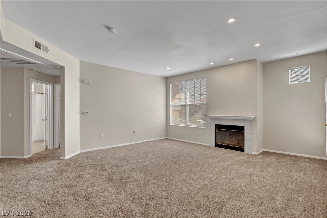 8555 West Russell Road, Unit 2091 Las Vegas, NV 89113 - Photo 4 of 26 Living room featuring a gas fireplace, carpet floors, and recessed lighting