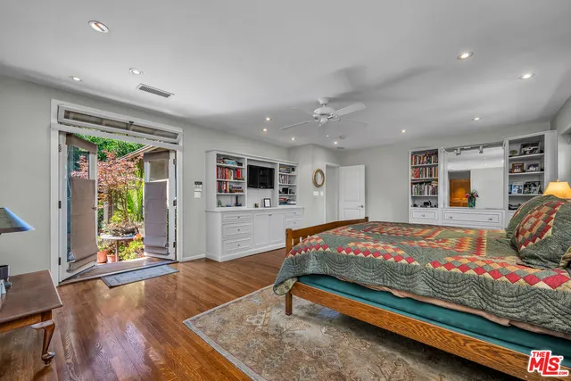 a bedroom with furniture and flat screen tv